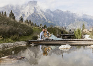 Brautpaar am Wasser mit Alpenpanorama und Spiegelung – Hochzeitsfotograf in Österreich